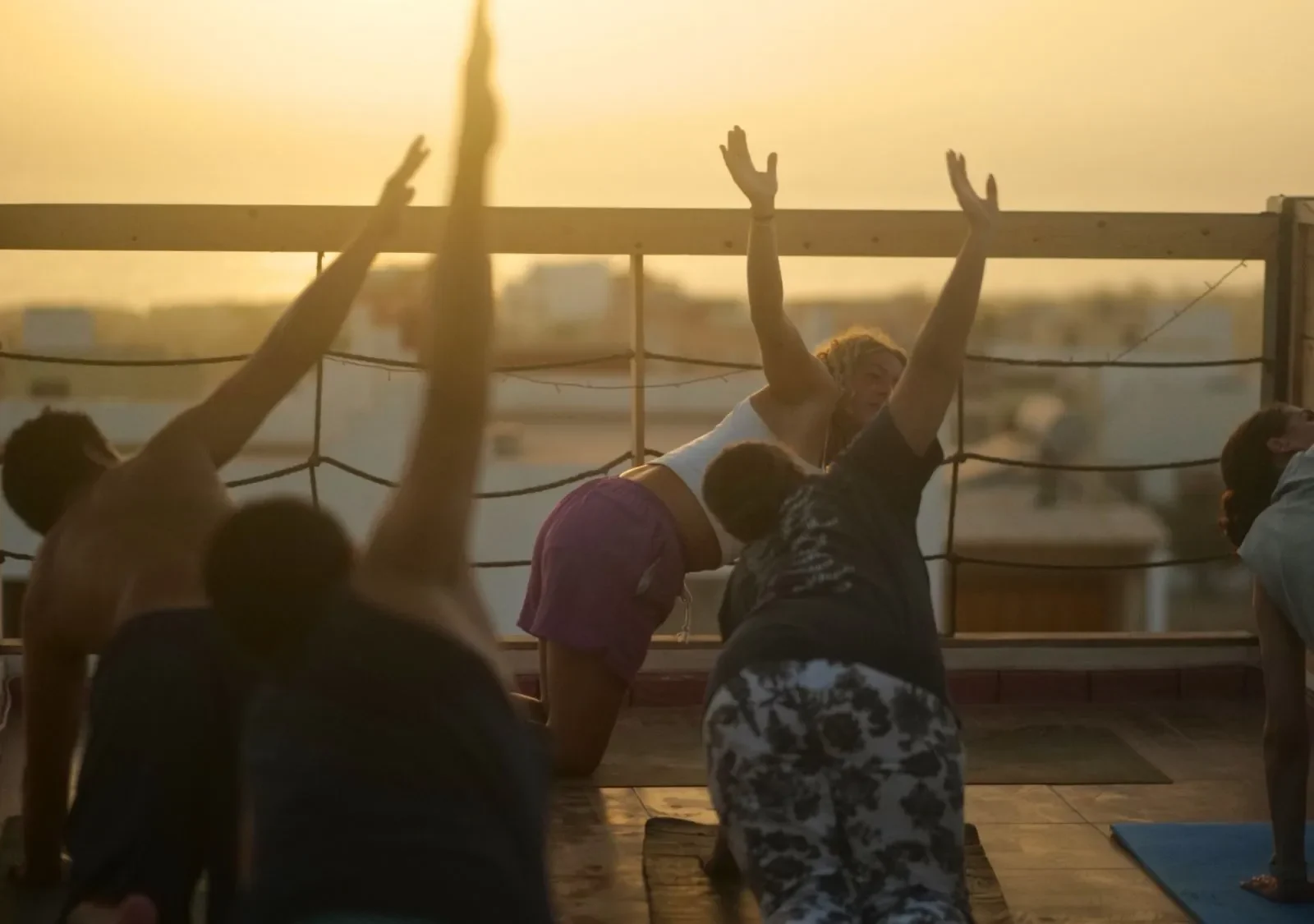 A yoga class on the rooftop at sunset