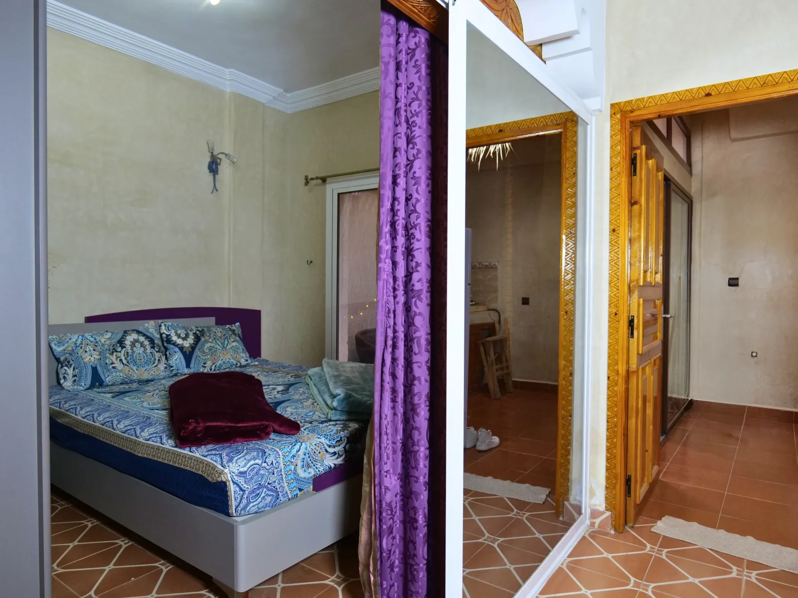The apartment bedroom with a double bed and a door to the hall