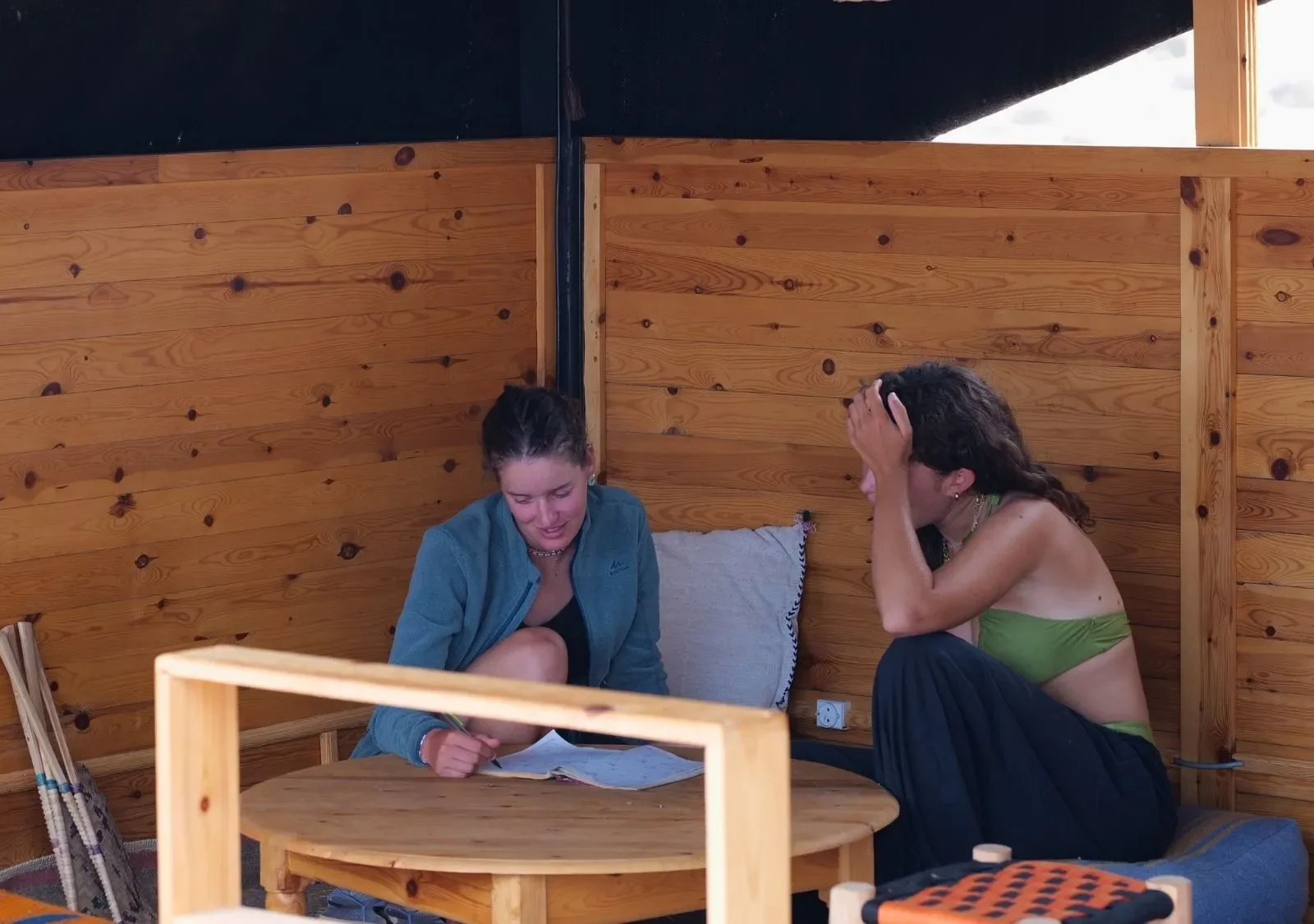 Two guests working with notebooks in the wooden lounge corner